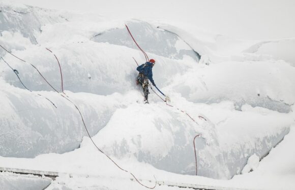 Bayern’s snow-covered stadium just like Mount Everest as man spotted climbing it